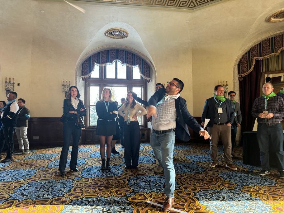 Team completing a creative challenge in an ornate hotel ballroom