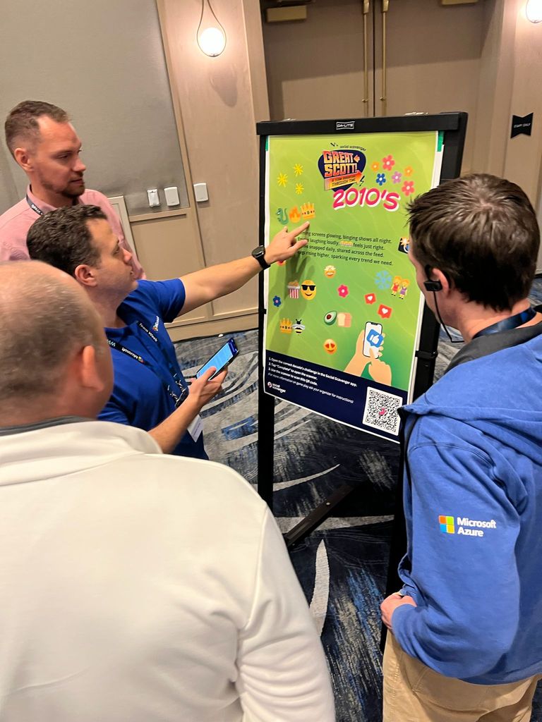 Team exploring a Great Scott interactive poster on an easel at a venue event