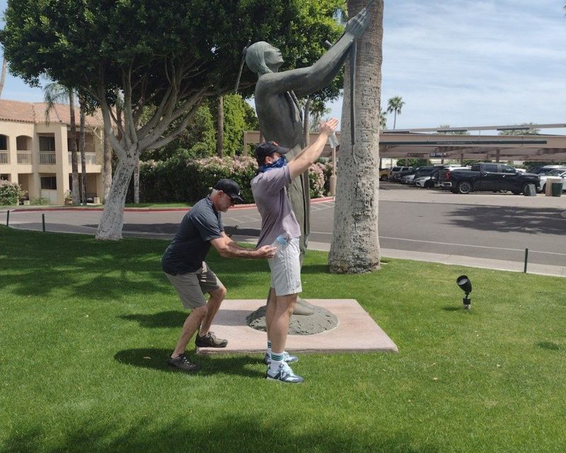 Team building activity at a park statue