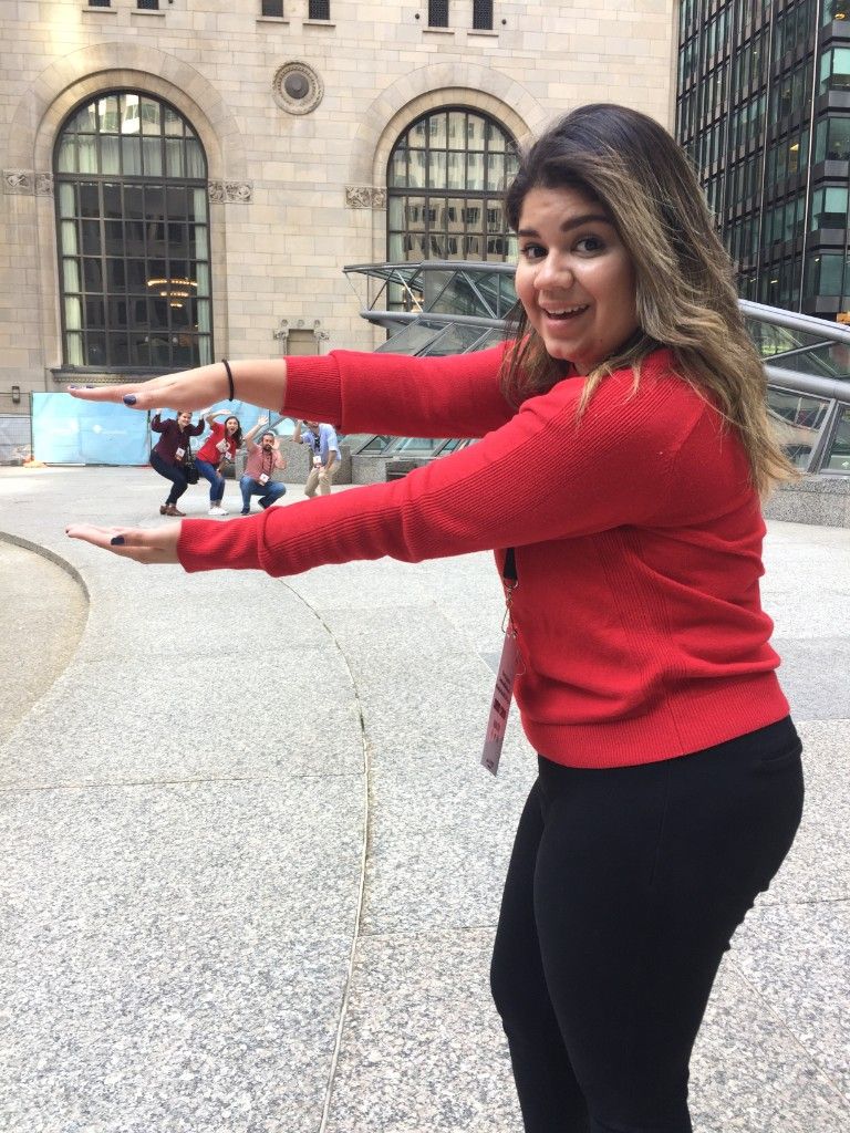 Player in a red sweater framing teammates during a city challenge