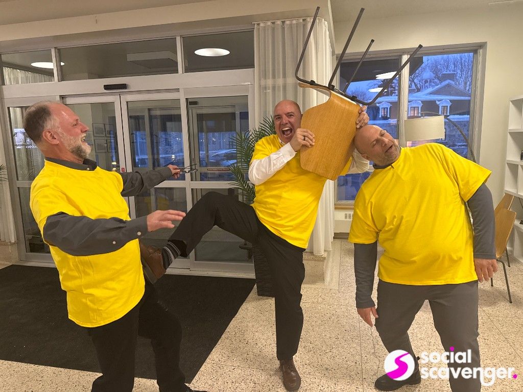 Players posing with a chair during a creative team challenge