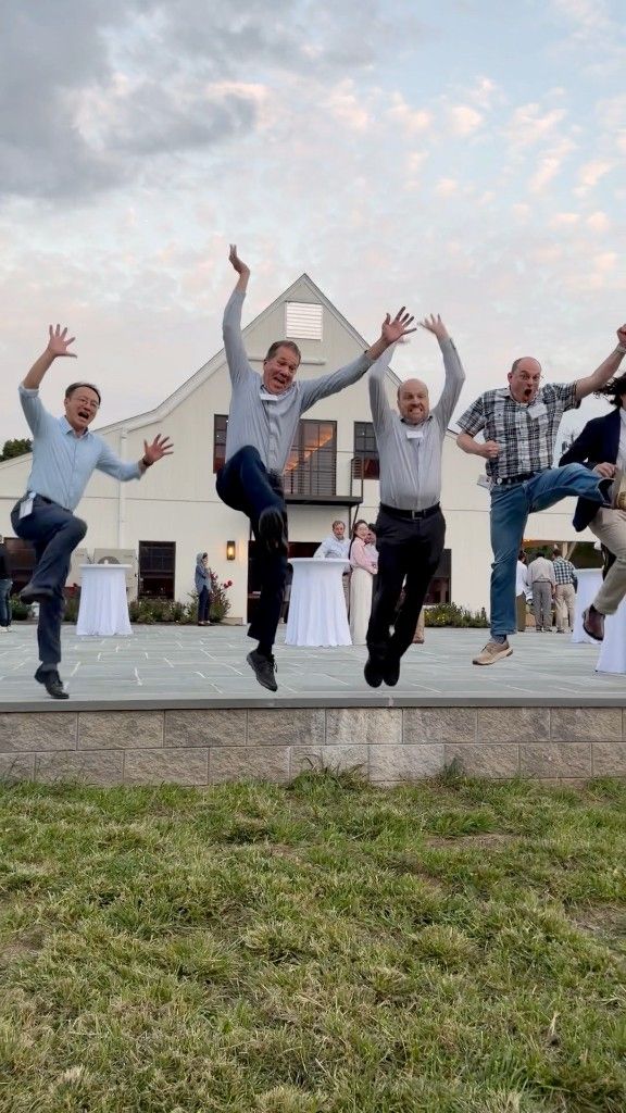 Team celebrating with a jump photo during an in-person Social Scavenger event